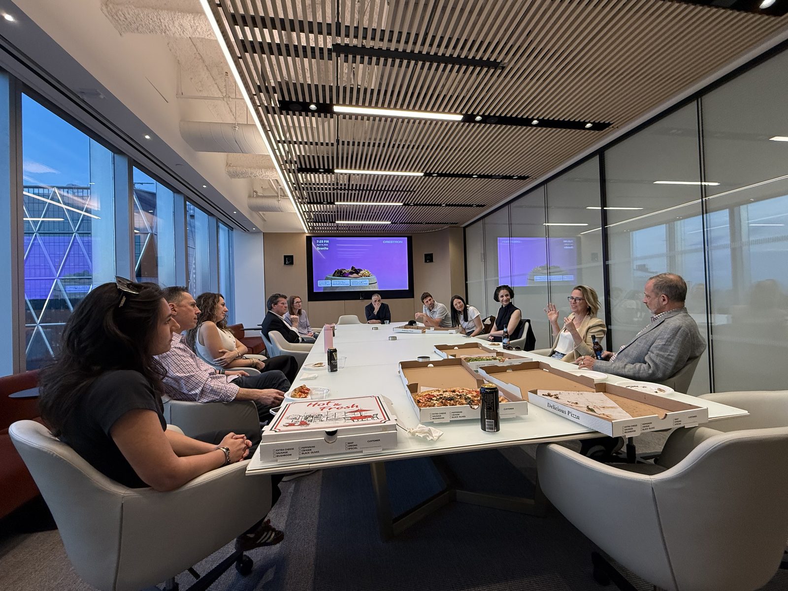 Members at a conference-room working session with pizza